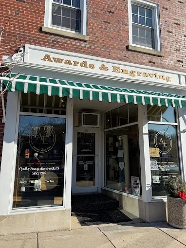 The Awards & Engraving storefront with its green-and-white awning on Milwaukee Avenue in downtown Libertyville